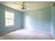 Bedroom featuring blue walls, a window, and a ceiling fan at 5640 Dapple Ct, Indianapolis, IN 46228