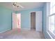 Light-blue bedroom with a large window, closet, and an open door at 5640 Dapple Ct, Indianapolis, IN 46228