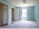 Light colored bedroom with carpet, window and large closet at 5640 Dapple Ct, Indianapolis, IN 46228
