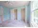 Bright bedroom features a ceiling fan, a window for natural light, and closet perfect for storage at 5640 Dapple Ct, Indianapolis, IN 46228