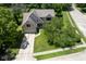 An aerial view shows the house, garage, driveway, sidewalk, and mature shade trees at 5640 Dapple Ct, Indianapolis, IN 46228