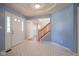 Bright foyer featuring light blue walls, unique tile flooring, and a wooden staircase at 5640 Dapple Ct, Indianapolis, IN 46228