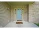 Inviting front porch with a blue front door, brick surround, and a 'welcome' mat at 5640 Dapple Ct, Indianapolis, IN 46228