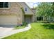 Inviting front entrance with brick surround, covered porch and well-maintained lawn at 5640 Dapple Ct, Indianapolis, IN 46228