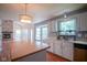 Bright kitchen with white cabinets, stainless steel appliances, and a view into the living room and fireplace at 5640 Dapple Ct, Indianapolis, IN 46228