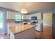 Kitchen with white cabinets, stainless steel appliances, and a large island, perfect for cooking and entertaining at 5640 Dapple Ct, Indianapolis, IN 46228