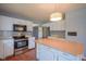 Spacious kitchen with stainless steel appliances, white cabinetry, and a center island, offering ample space at 5640 Dapple Ct, Indianapolis, IN 46228