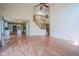 Open-concept living room with hardwood floors, staircase, and kitchen view offering a spacious and inviting atmosphere at 5640 Dapple Ct, Indianapolis, IN 46228