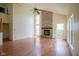 Spacious living room with a brick fireplace, high ceilings, and large windows, creating a cozy ambiance at 5640 Dapple Ct, Indianapolis, IN 46228