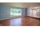 Large living room with light blue walls, hardwood floors, and ample natural light from large windows at 5640 Dapple Ct, Indianapolis, IN 46228