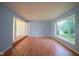 Spacious living room with light blue walls, hardwood floors, and natural light from a large window at 5640 Dapple Ct, Indianapolis, IN 46228