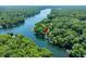 High angle view of homes along a lake with a marker, surrounded by lush greenery at 6254 Grosbeak Ct, Nineveh, IN 46164
