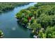 An aerial view of a lake features tree-lined properties with docks along the serene water at 6254 Grosbeak Ct, Nineveh, IN 46164