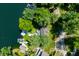 An aerial view of a lakefront property showcasing a home with a dock and lush greenery at 6254 Grosbeak Ct, Nineveh, IN 46164
