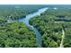 Gorgeous aerial view of a serene lake surrounded by lush green forests and waterfront homes at 6254 Grosbeak Ct, Nineveh, IN 46164