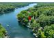 Stunning aerial view of a lakefront property surrounded by lush greenery at 6254 Grosbeak Ct, Nineveh, IN 46164