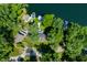 An aerial view of a waterfront home highlighting a dock and a canopy of trees at 6254 Grosbeak Ct, Nineveh, IN 46164