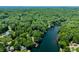 Scenic aerial view of homes along a lake, surrounded by a canopy of trees at 6254 Grosbeak Ct, Nineveh, IN 46164