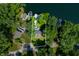 An aerial view outlines a waterfront home with mature trees, a private dock, and lake access at 6254 Grosbeak Ct, Nineveh, IN 46164