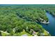Expansive aerial view showcasing a lake community surrounded by dense foliage at 6254 Grosbeak Ct, Nineveh, IN 46164