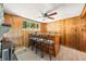 Charming bar area with wood paneling, seating for four, and a ceiling fan at 6254 Grosbeak Ct, Nineveh, IN 46164