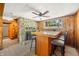 Basement bar area with unique stone fireplace and wood paneled walls at 6254 Grosbeak Ct, Nineveh, IN 46164