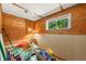 Unfinished basement with wood paneling and a window providing natural light at 6254 Grosbeak Ct, Nineveh, IN 46164
