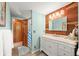 Stylish bathroom features a vanity with a marble countertop and wood accent wall at 6254 Grosbeak Ct, Nineveh, IN 46164