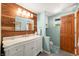 Well-lit bathroom with a wood accent wall, a marble-top vanity, and a sleek design at 6254 Grosbeak Ct, Nineveh, IN 46164