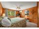 Comfortable bedroom with wood paneling, ceiling fan, and bright natural light at 6254 Grosbeak Ct, Nineveh, IN 46164