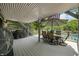The covered deck offers outdoor comfort, with a fan and views of the lake at 6254 Grosbeak Ct, Nineveh, IN 46164