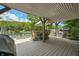 Outdoor dining on the covered deck with a beautiful view of the water and trees at 6254 Grosbeak Ct, Nineveh, IN 46164