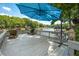 Spacious deck with comfortable lounge chairs and a blue umbrella, overlooking beautiful lake views at 6254 Grosbeak Ct, Nineveh, IN 46164