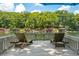 Relaxing deck featuring comfortable lounge chairs with picturesque views of the lake and surrounding greenery at 6254 Grosbeak Ct, Nineveh, IN 46164