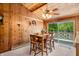 Charming dining room with wood paneling, a ceiling fan, and sliding glass doors to the outside at 6254 Grosbeak Ct, Nineveh, IN 46164