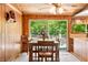 Cozy dining room features wood paneled walls and sliding glass doors to the outside at 6254 Grosbeak Ct, Nineveh, IN 46164