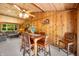 This dining room offers wood paneled walls, a ceiling fan, and an adjoined sitting area at 6254 Grosbeak Ct, Nineveh, IN 46164