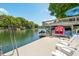 Lakeside dock with covered boat storage, lounge chairs and easy water access on a sunny day at 6254 Grosbeak Ct, Nineveh, IN 46164