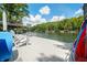 Beautiful dock with white chairs overlooking the calm lake waters and tree-lined shores at 6254 Grosbeak Ct, Nineveh, IN 46164