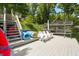Lakeside dock featuring white Adirondack chairs and lake toys for enjoying the water at 6254 Grosbeak Ct, Nineveh, IN 46164