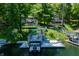 Multi-level dock with boat lift, lounge area, and stairs leading up to lakeside home at 6254 Grosbeak Ct, Nineveh, IN 46164