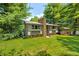 Charming home featuring a stone chimney, flower boxes and a spacious front yard at 6254 Grosbeak Ct, Nineveh, IN 46164