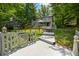 Picturesque home exterior with a spacious deck area surrounded by mature trees and lush landscaping at 6254 Grosbeak Ct, Nineveh, IN 46164
