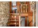 Unique foyer with a stone accent wall and rustic wooden staircase leading to the upper level at 6254 Grosbeak Ct, Nineveh, IN 46164