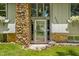 Inviting front entrance featuring a stone facade, glass door, and flower boxes at 6254 Grosbeak Ct, Nineveh, IN 46164