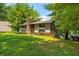 Charming home exterior with stone accents, a well-maintained lawn, and mature trees at 6254 Grosbeak Ct, Nineveh, IN 46164