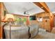 Cozy living room featuring wood paneling, comfortable seating, and a sliding glass door to the outside deck at 6254 Grosbeak Ct, Nineveh, IN 46164