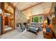 Cozy living room featuring a stone fireplace, wood paneling, and comfortable seating at 6254 Grosbeak Ct, Nineveh, IN 46164