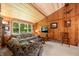 Comfortable living room with a vaulted ceiling, wood paneling, and a view of the outdoors at 6254 Grosbeak Ct, Nineveh, IN 46164