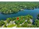 Picturesque aerial view of a lakeside community surrounded by lush greenery and a calm lake at 6300 Grouse Dr, Nineveh, IN 46164
